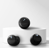 Three black cylindrical mini magnetic wifi cameras on a white platform with a light gray background