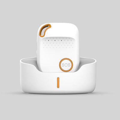 White and orange personal alarm device with an SOS button, shown standing in a matching charging dock.