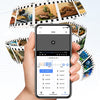 Hand holding a smartphone displaying camera playback, with film strips showing reptiles and aquariums in the background.