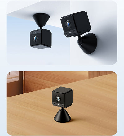 Two black cube-shaped cameras with cone bases, one mounted on a ceiling and one placed on a wooden table.